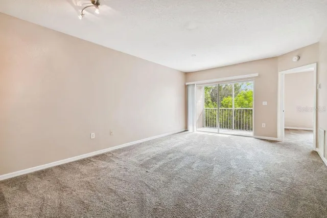 an aerial view of a house with swimming pool and outdoor seating