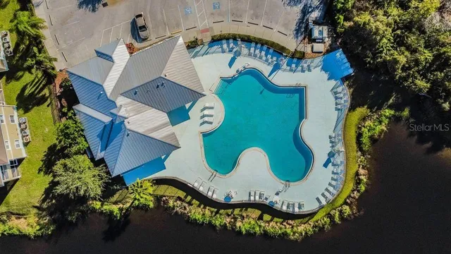 an aerial view of house with yard swimming pool and outdoor seating
