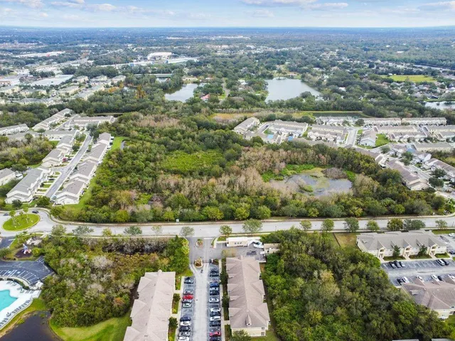 an aerial view of a house with garden space and lake view