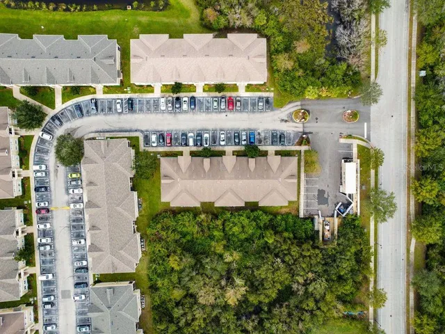 an aerial view of residential houses with outdoor space and swimming pool