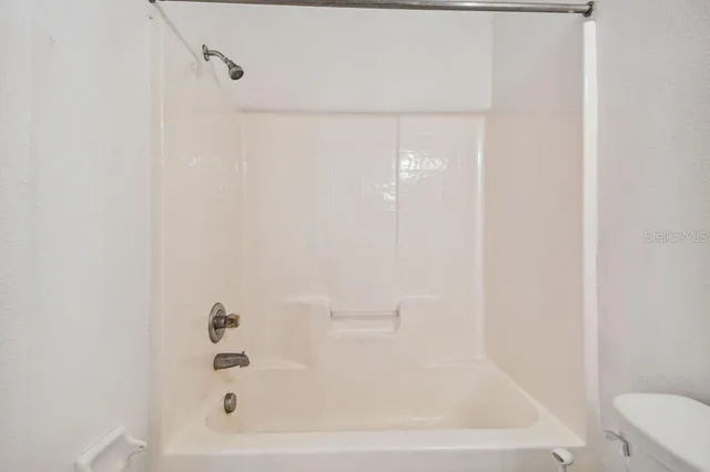 a view of an empty room with windows