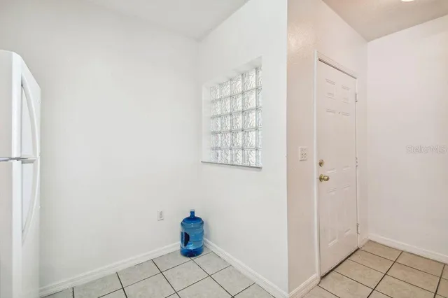 a kitchen with a white stove refrigerator and cabinets