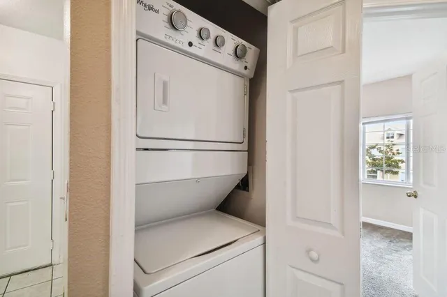a bathroom with a granite countertop sink and a toilet