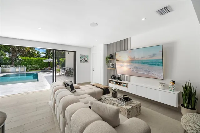 a bedroom with a large bed and a potted plant