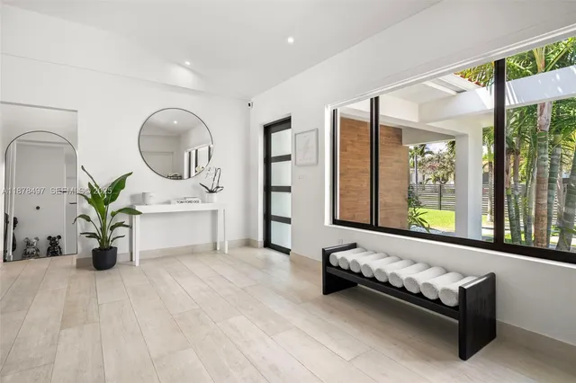 a dining room with furniture and large windows