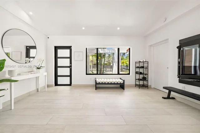 a bed room with two bed and a large window