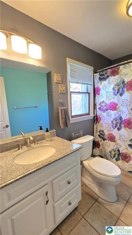 194 Springhouse Road Allentown, PA 18104 - Photo 22 of 34 This bright bathroom features a vanity with granite counters and a tiled floor.