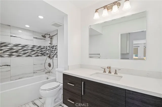 a view of a big room with wooden floor and a ceiling fan