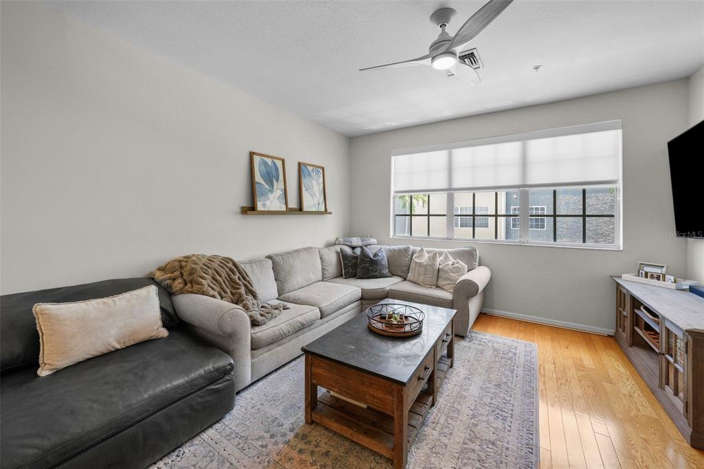 1451 Harbour Walk Road Tampa, FL 33602 - Photo 13 of 51 a living room with furniture a flat screen tv and a window