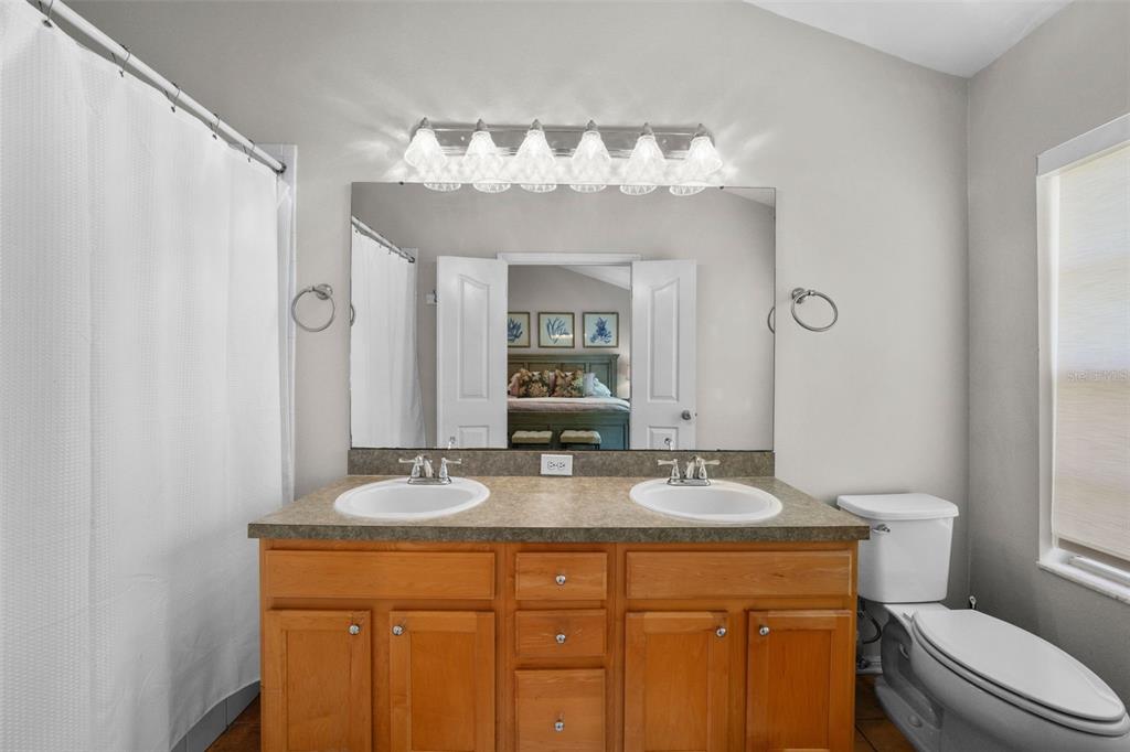 1451 Harbour Walk Road Tampa, FL 33602 - Photo 22 of 51 a bathroom with a granite countertop sink a toilet and a mirror