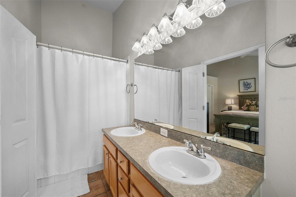 1451 Harbour Walk Road Tampa, FL 33602 - Photo 23 of 51 a bathroom with a granite countertop sink a mirror and a vanity