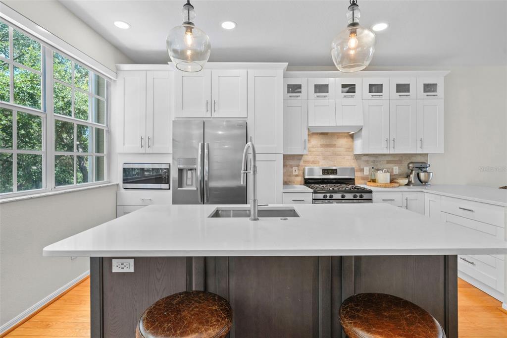 1451 Harbour Walk Road Tampa, FL 33602 - Photo 3 of 51 a kitchen with a sink a center island cabinets and stainless steel appliances