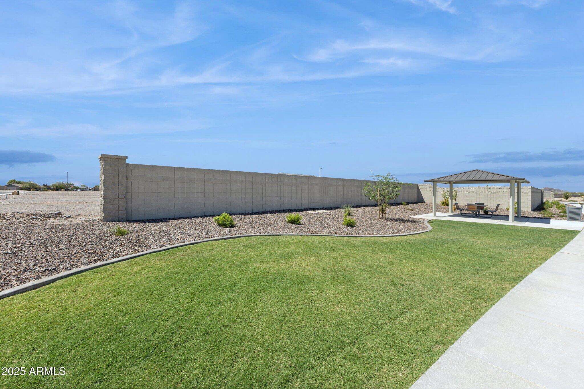 549 West Freedom Street Florence, AZ 85132 - Photo 24 of 26 a view of a garden with a building in the background