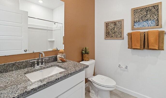 549 West Freedom Street Florence, AZ 85132 - Photo 7 of 26 a bathroom with a granite countertop sink and a mirror