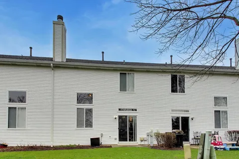 a view of a house with a backyard and deck