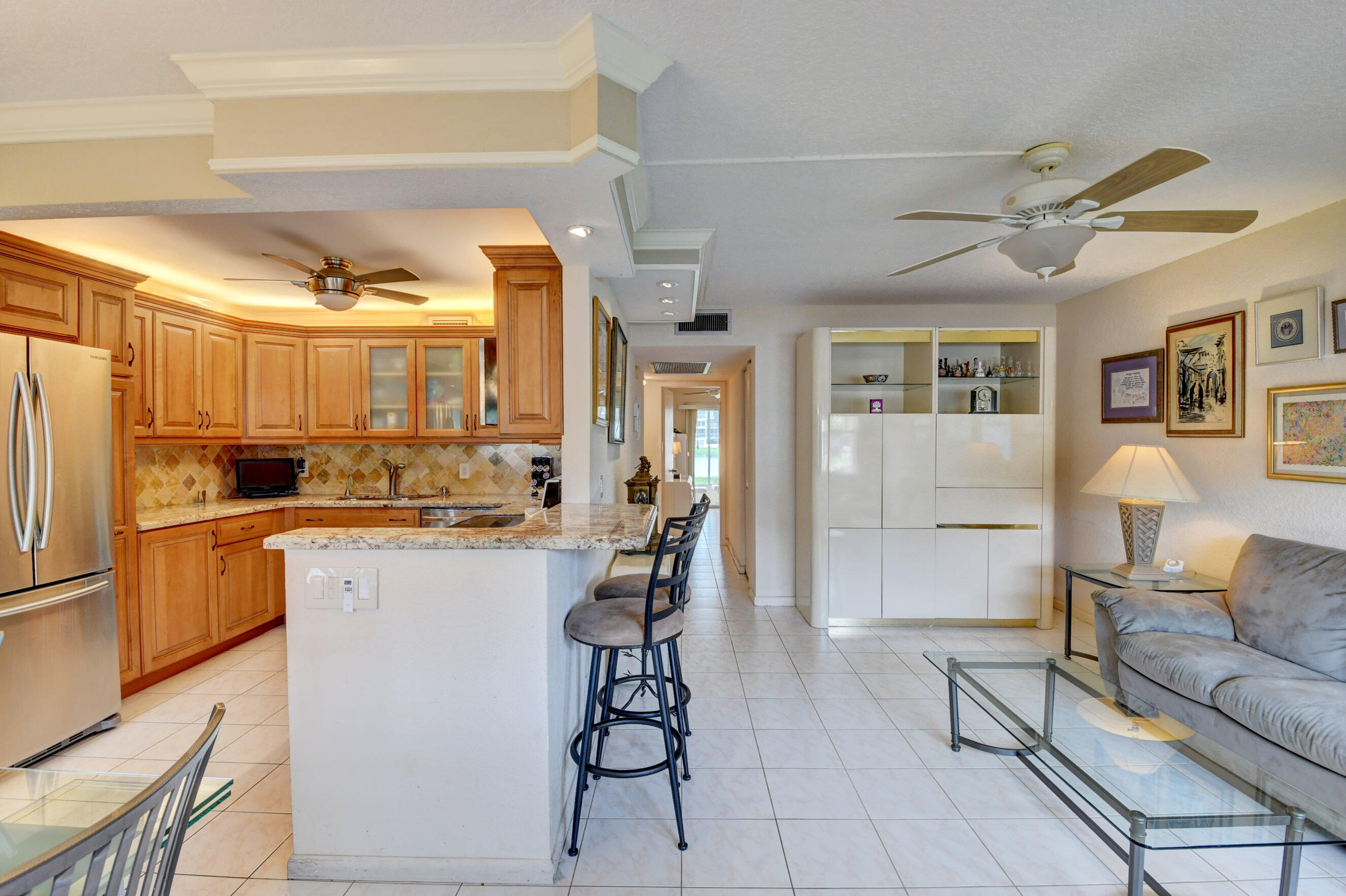 1045 Wolverton C, Unit 1045 Boca Raton, FL 33434 - Photo 1 of 67 a kitchen with stainless steel appliances granite countertop a refrigerator and a stove top oven