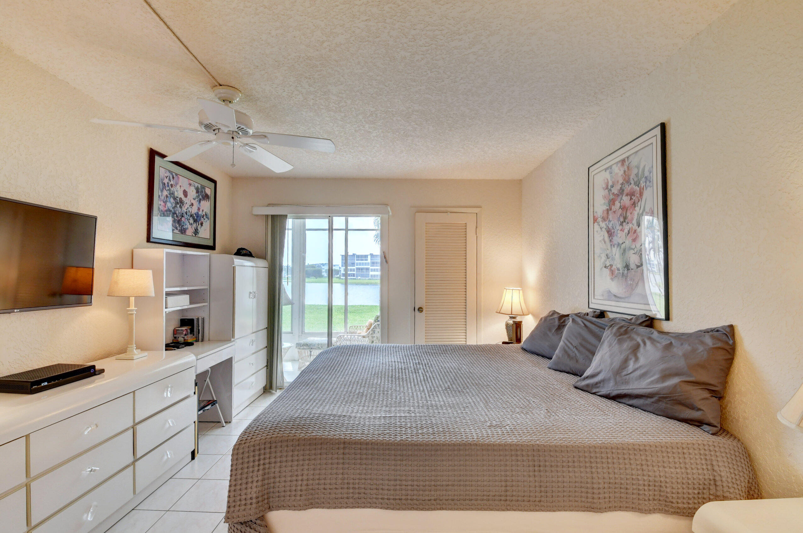 1045 Wolverton C, Unit 1045 Boca Raton, FL 33434 - Photo 19 of 67 a bedroom with a large bed and a window