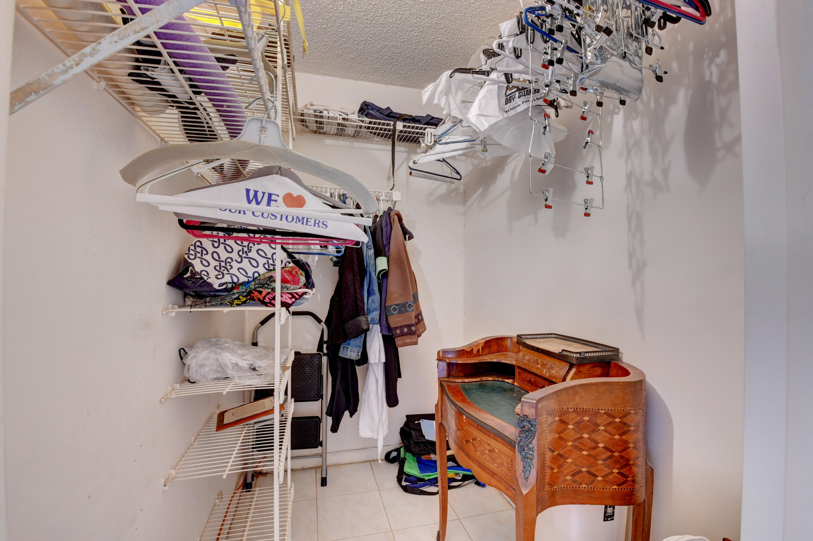 1045 Wolverton C, Unit 1045 Boca Raton, FL 33434 - Photo 25 of 67 a view of walk in closet with clothes and shoes