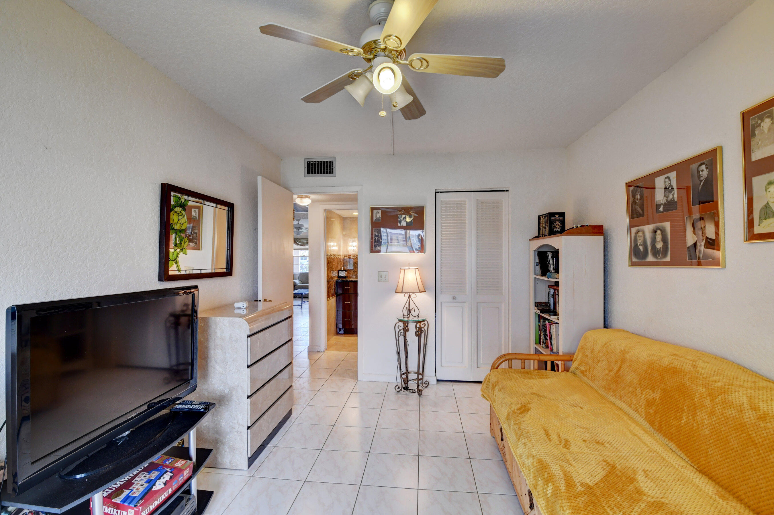 1045 Wolverton C, Unit 1045 Boca Raton, FL 33434 - Photo 27 of 67 a living room with furniture and a flat screen tv