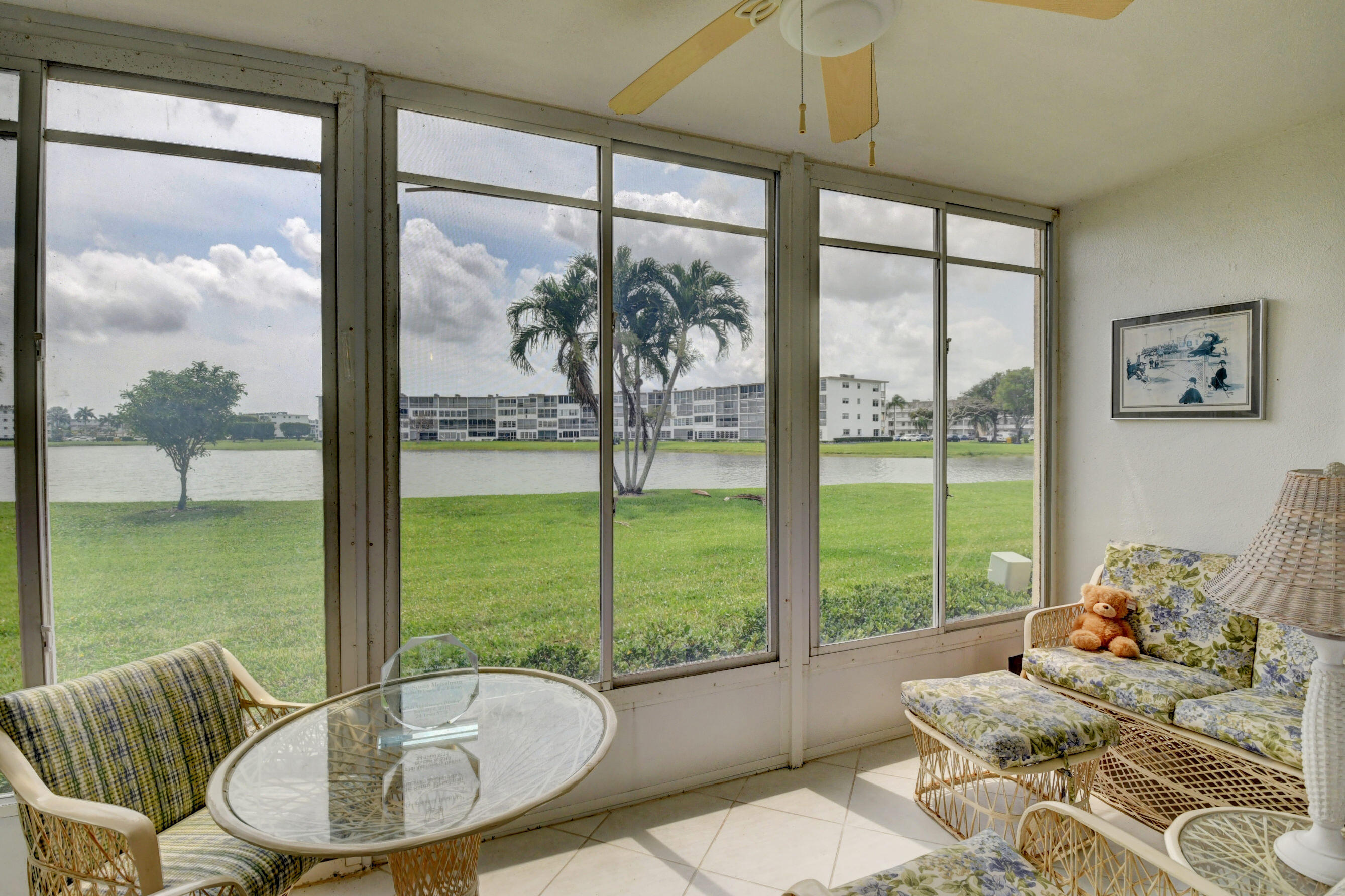 1045 Wolverton C, Unit 1045 Boca Raton, FL 33434 - Photo 28 of 67 a living room with large windows