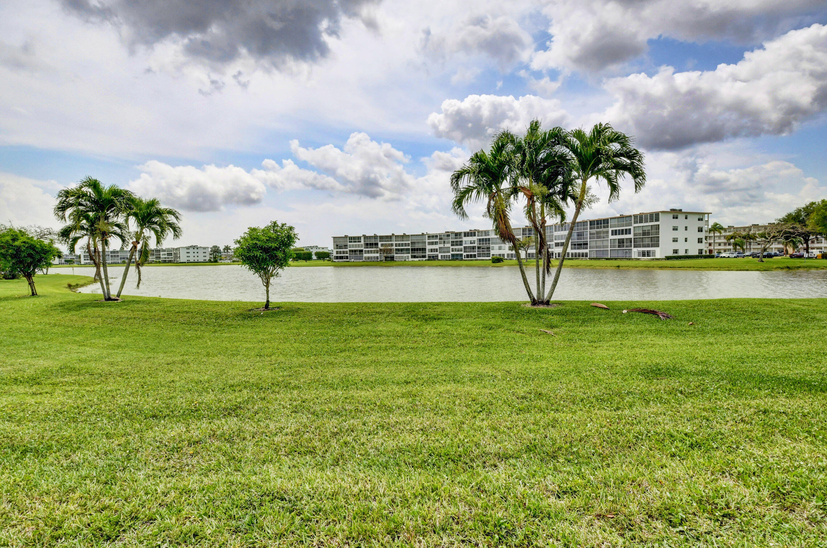 1045 Wolverton C, Unit 1045 Boca Raton, FL 33434 - Photo 31 of 67 a view of lake with and trees