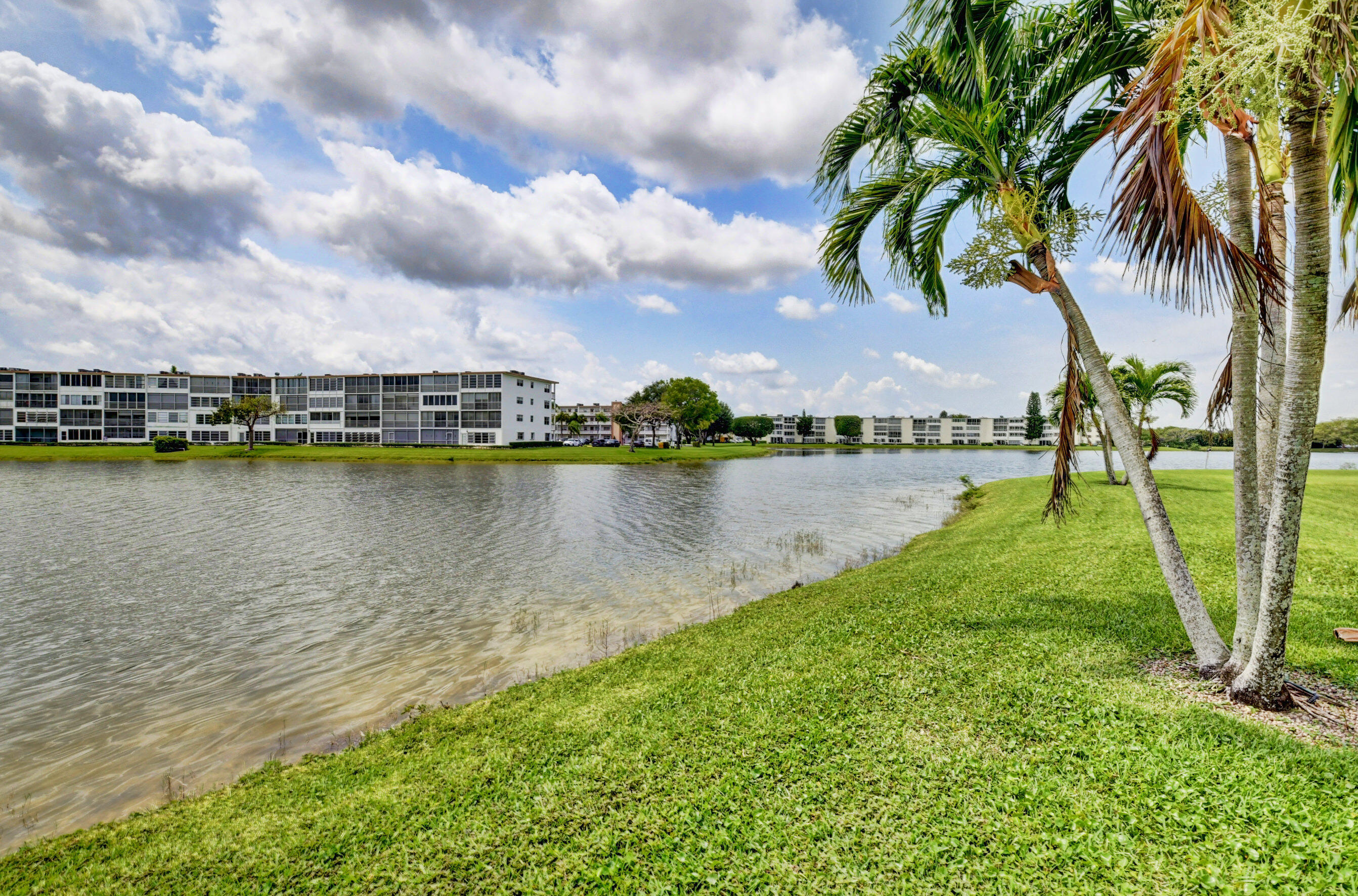 1045 Wolverton C, Unit 1045 Boca Raton, FL 33434 - Photo 33 of 67 a view of a lake with a big yard