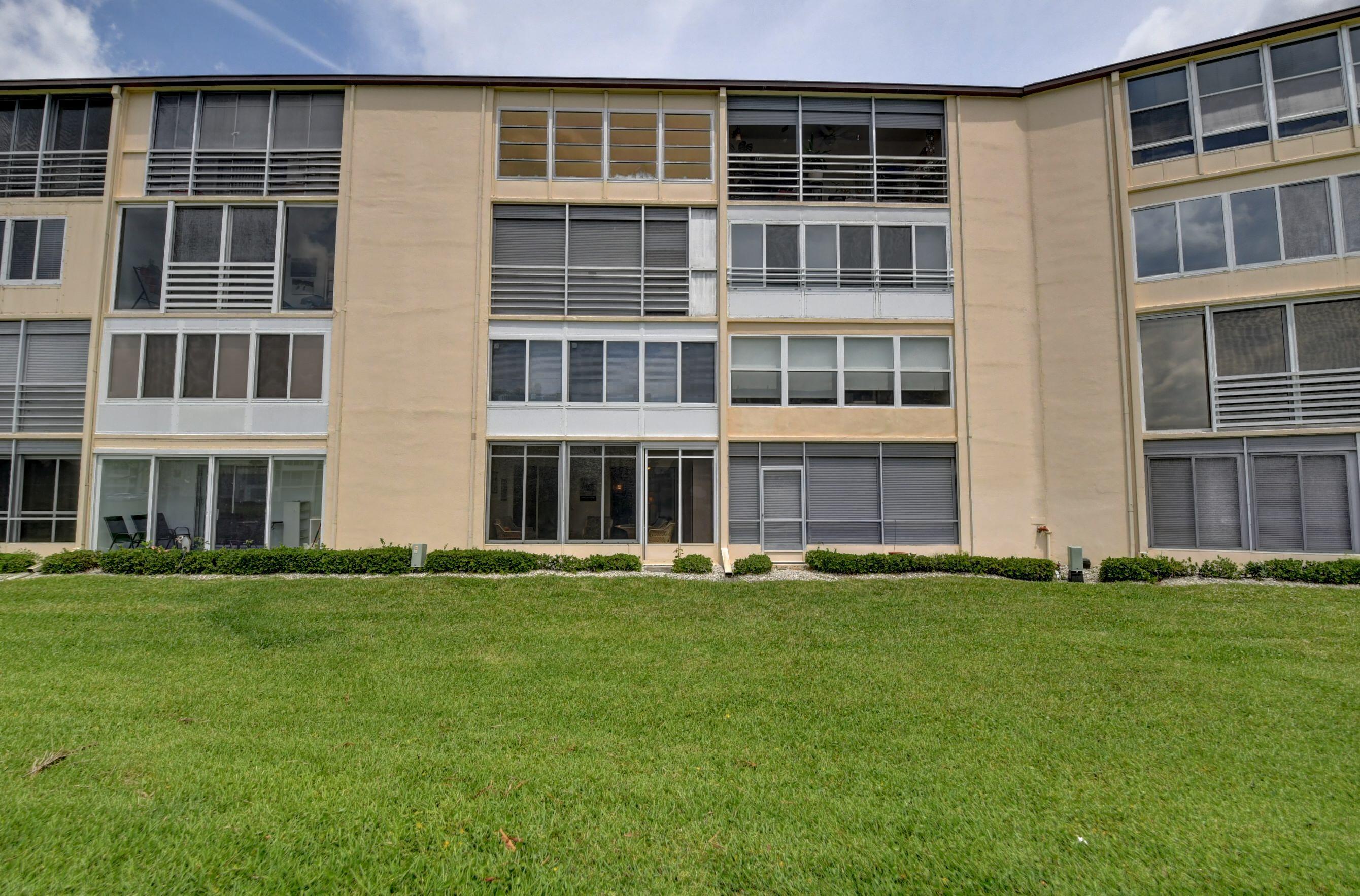 1045 Wolverton C, Unit 1045 Boca Raton, FL 33434 - Photo 34 of 67 a big building with a big yard