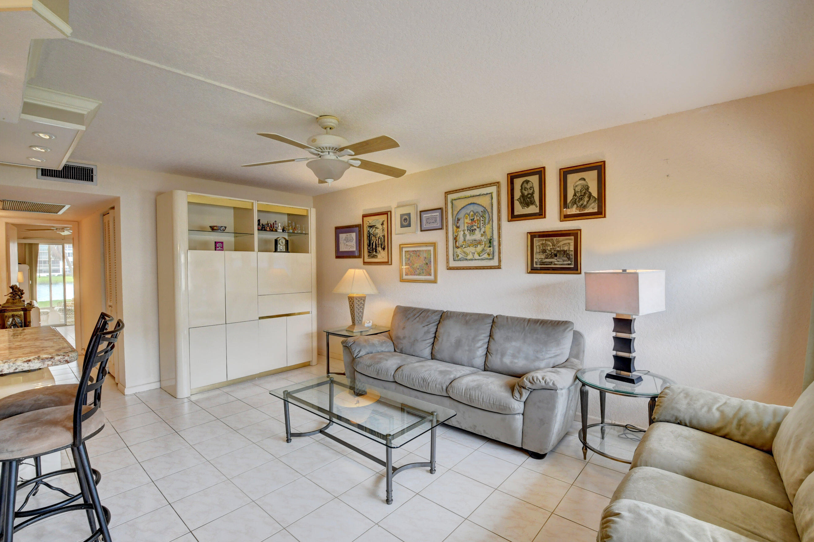 1045 Wolverton C, Unit 1045 Boca Raton, FL 33434 - Photo 4 of 67 a living room with furniture and a wooden floor
