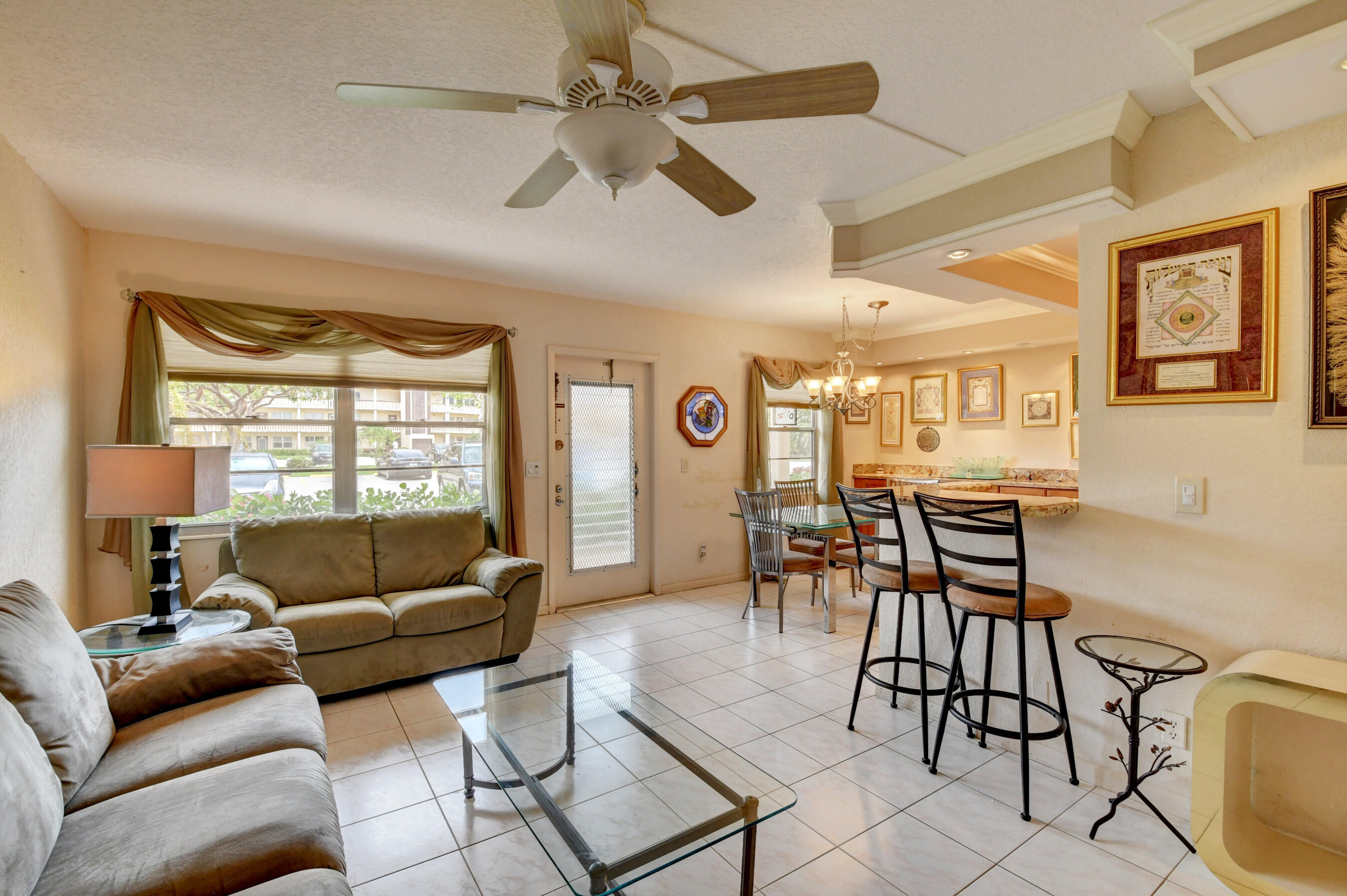 1045 Wolverton C, Unit 1045 Boca Raton, FL 33434 - Photo 8 of 67 a living room with furniture and a large window
