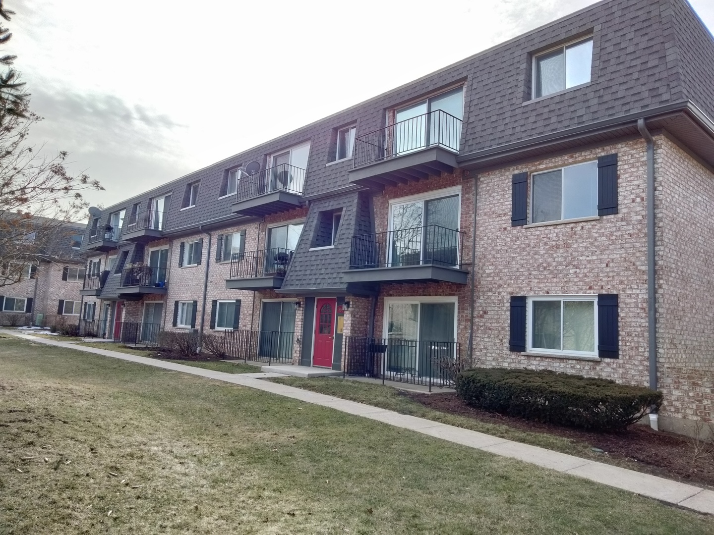 896 South Plum Grove Road, Unit 217 Palatine, IL 60067 - Photo 1 of 15 a front view of a building with a garden