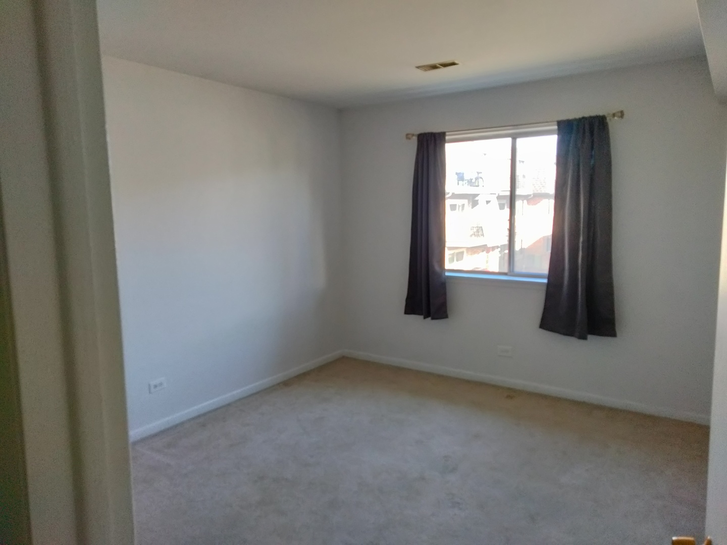 896 South Plum Grove Road, Unit 217 Palatine, IL 60067 - Photo 15 of 15 a view of an empty room with a window