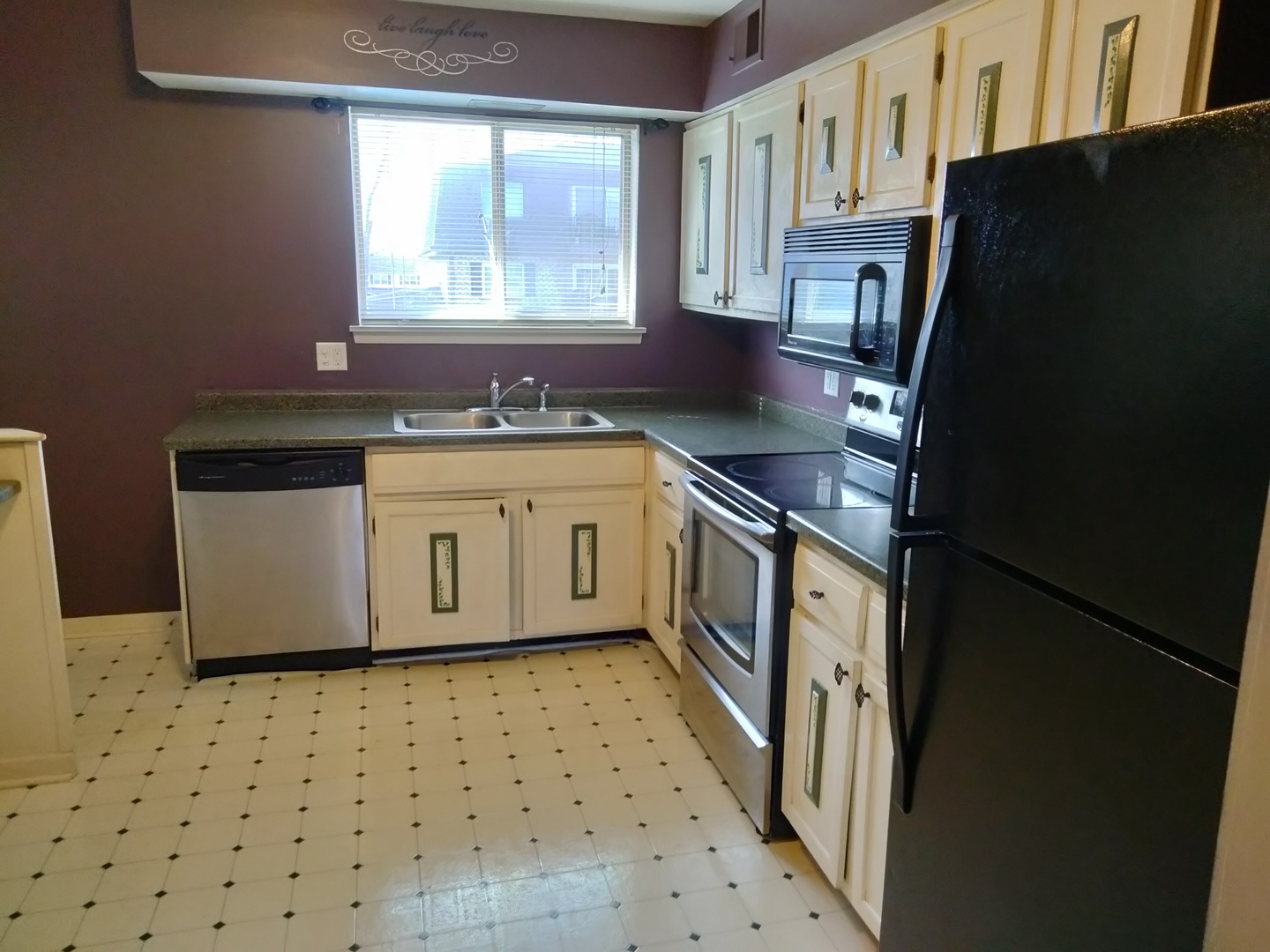 896 South Plum Grove Road, Unit 217 Palatine, IL 60067 - Photo 3 of 15 a kitchen with stainless steel appliances a sink a stove a refrigerator a window