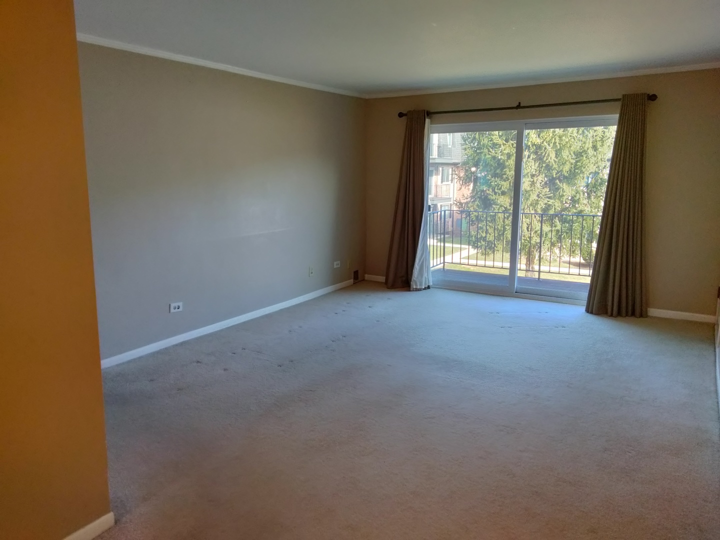 896 South Plum Grove Road, Unit 217 Palatine, IL 60067 - Photo 7 of 15 a view of an empty room with a balcony
