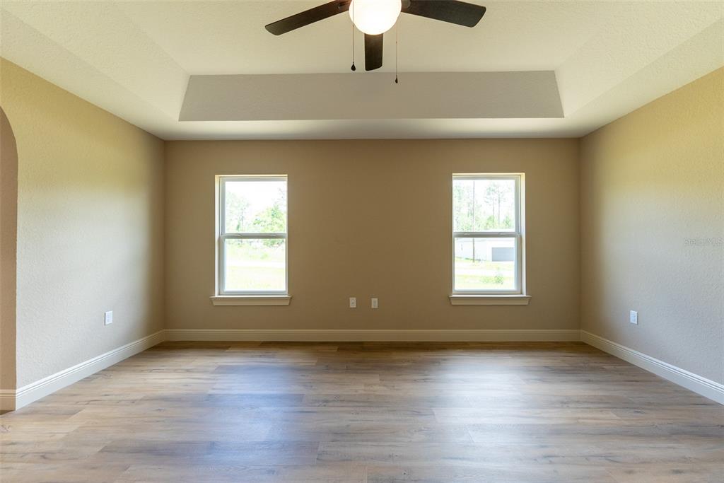 10 Cypress Loop Ocala, FL 34472 - Photo 36 of 65 an empty room with wooden floor and windows