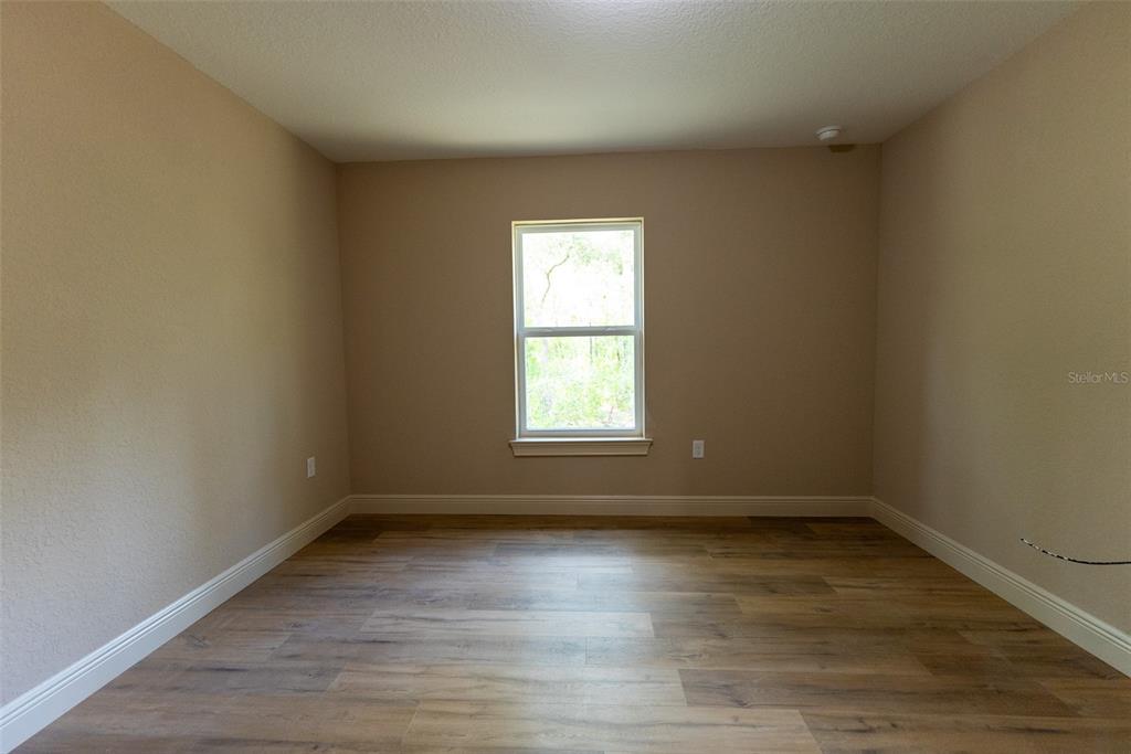 10 Cypress Loop Ocala, FL 34472 - Photo 64 of 65 a view of empty room with wooden floor and fan