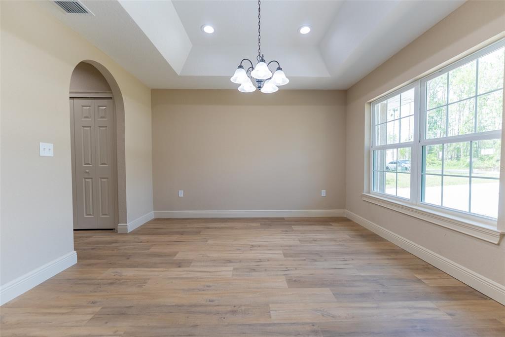 10 Cypress Loop Ocala, FL 34472 - Photo 10 of 65 an empty room with chandelier fan and windows
