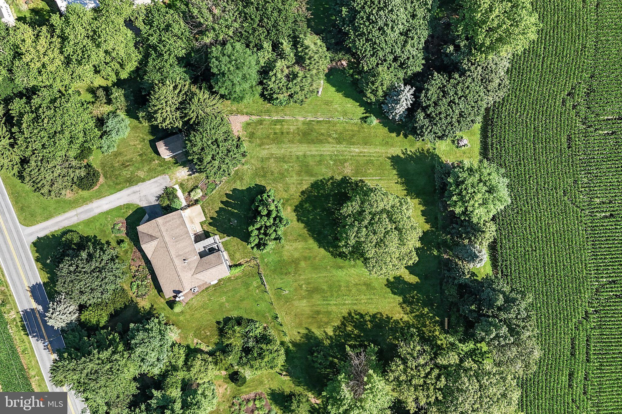 1277 South Colebrook Road Manheim, PA 17545 - Photo 54 of 65 Lush greenery surrounds a cozy home.