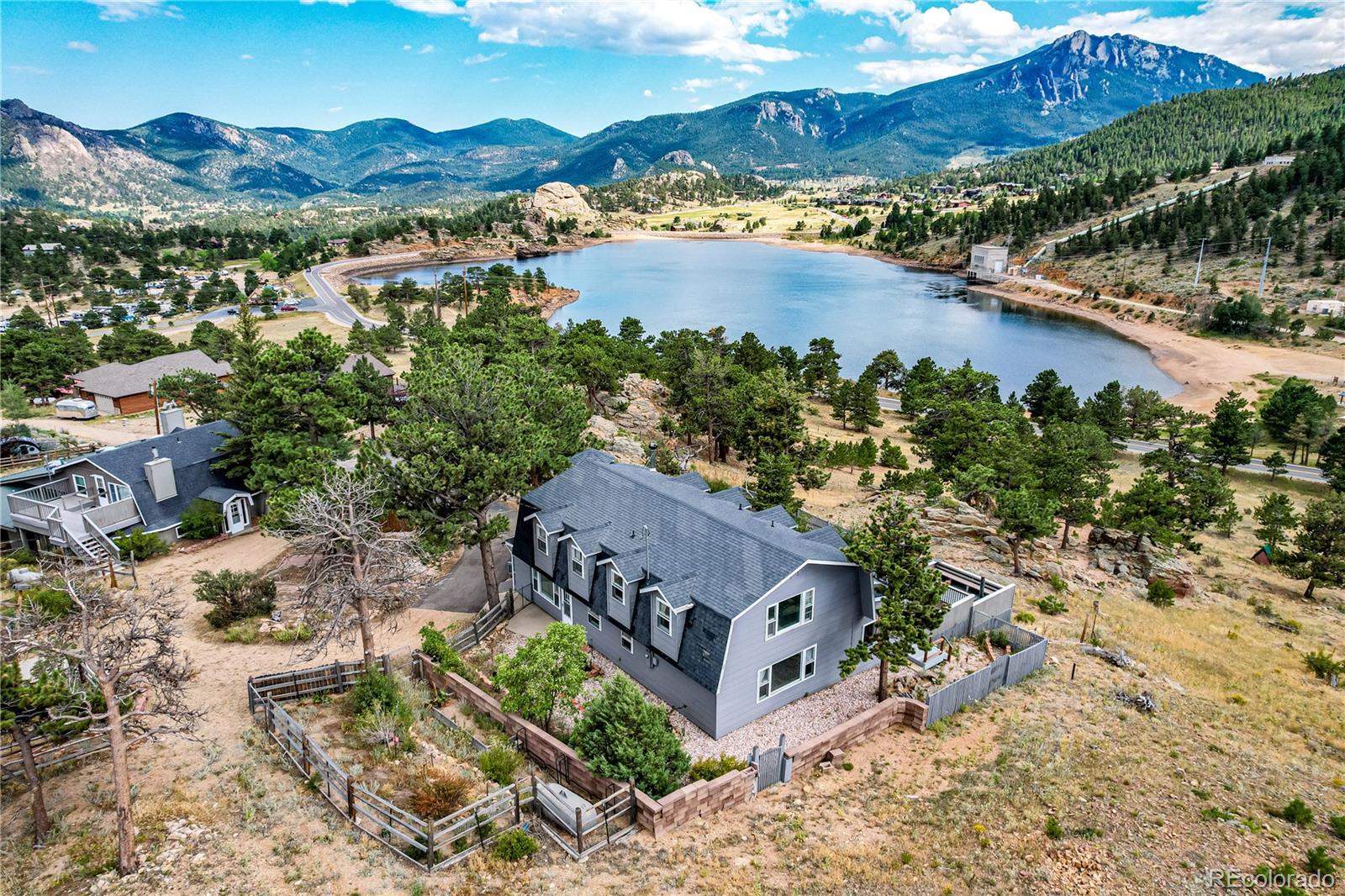 an aerial view of a house with a mountain