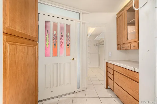 a hallway with cabinets and wooden floor