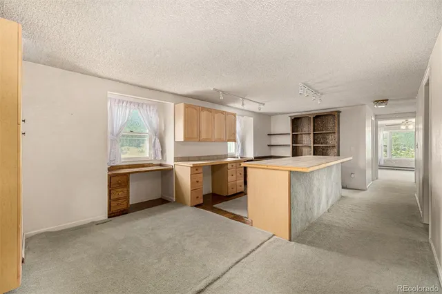 a kitchen with a stove top oven and cabinets