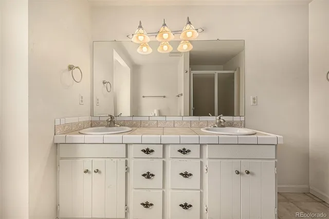 a bathroom with a sink vanity and a mirror