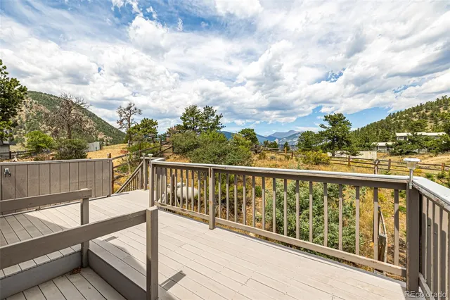 a view of balcony with wooden floor and fence
