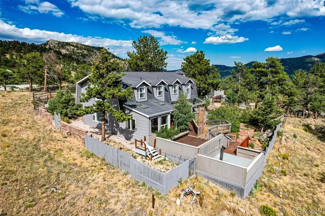 aerial view of a house with a yard