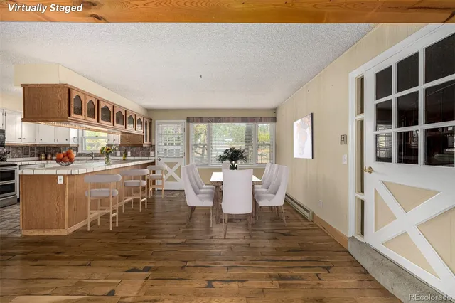 a dining room with furniture and wooden floor