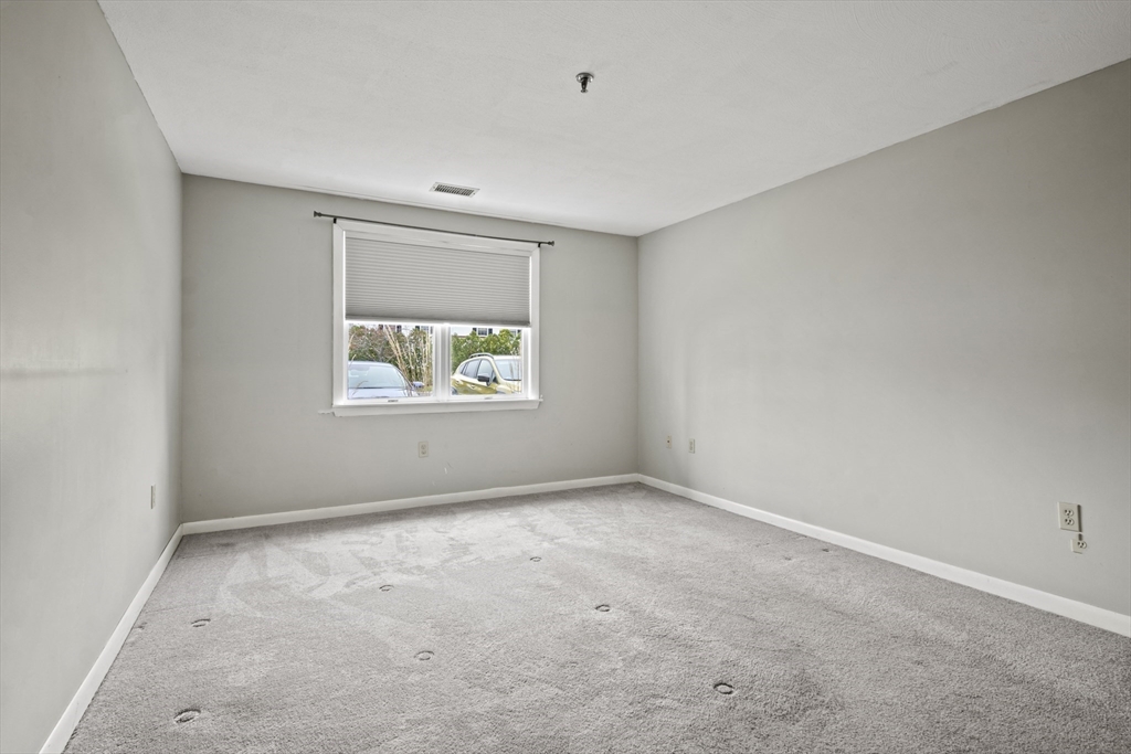 45 Christopher Drive, Unit 101 Methuen, MA 01844 - Photo 11 of 32 an empty room with windows