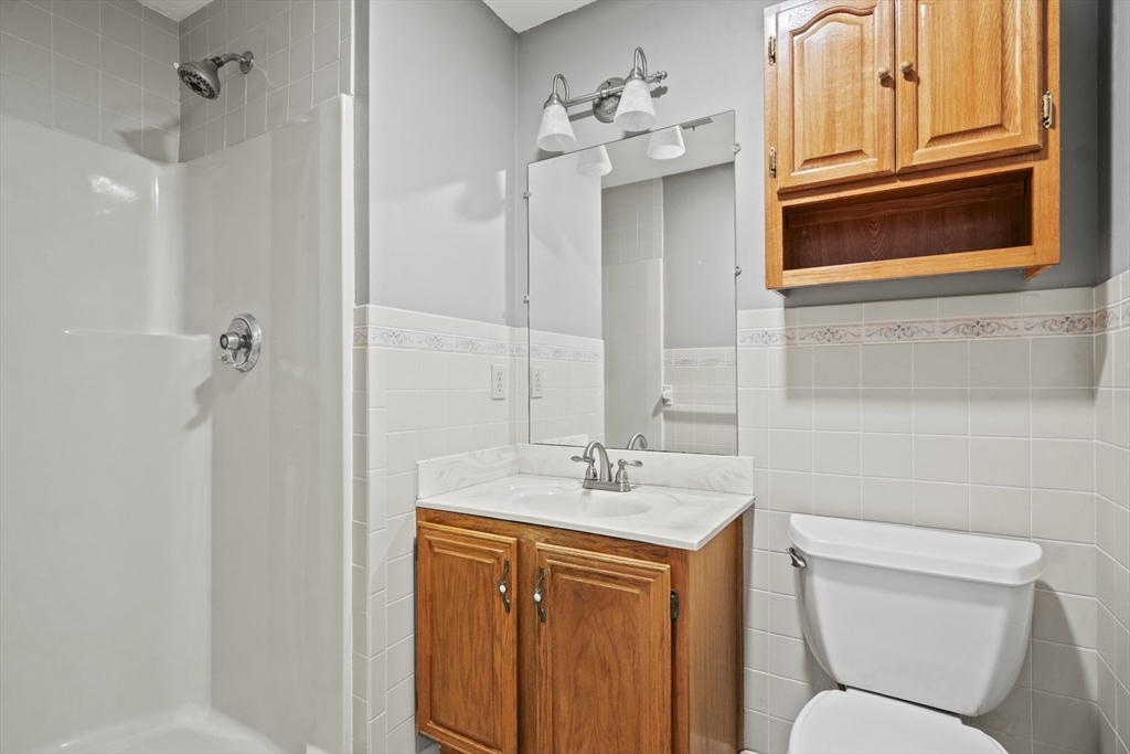 45 Christopher Drive, Unit 101 Methuen, MA 01844 - Photo 13 of 32 a bathroom with a toilet sink and mirror