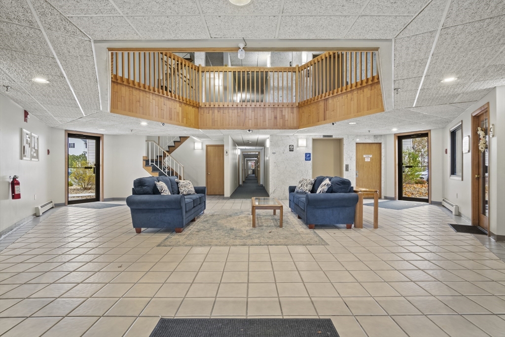 45 Christopher Drive, Unit 101 Methuen, MA 01844 - Photo 22 of 32 a living room with furniture and a chandelier