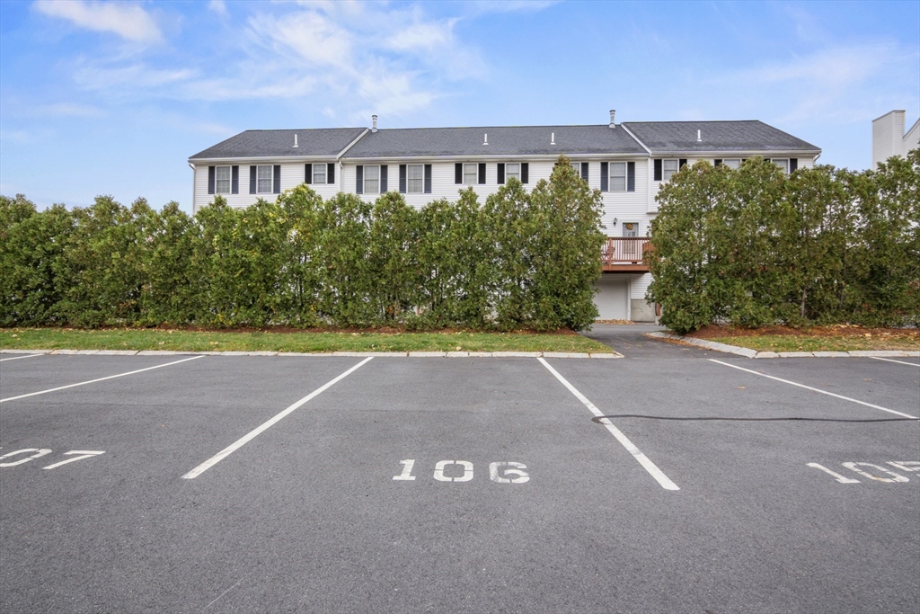 45 Christopher Drive, Unit 101 Methuen, MA 01844 - Photo 31 of 32 a front view of a house with a yard and a garage