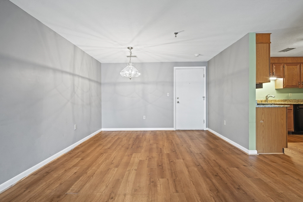 45 Christopher Drive, Unit 101 Methuen, MA 01844 - Photo 7 of 32 wooden floor in an empty room with a window