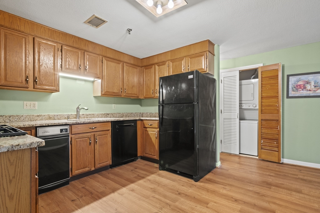 45 Christopher Drive, Unit 101 Methuen, MA 01844 - Photo 8 of 32 a kitchen with stainless steel appliances granite countertop a refrigerator and a stove